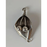 Silver steed leaf sterling silver pendant with textured silver leaf shape and two polished spherical beads nestled inside