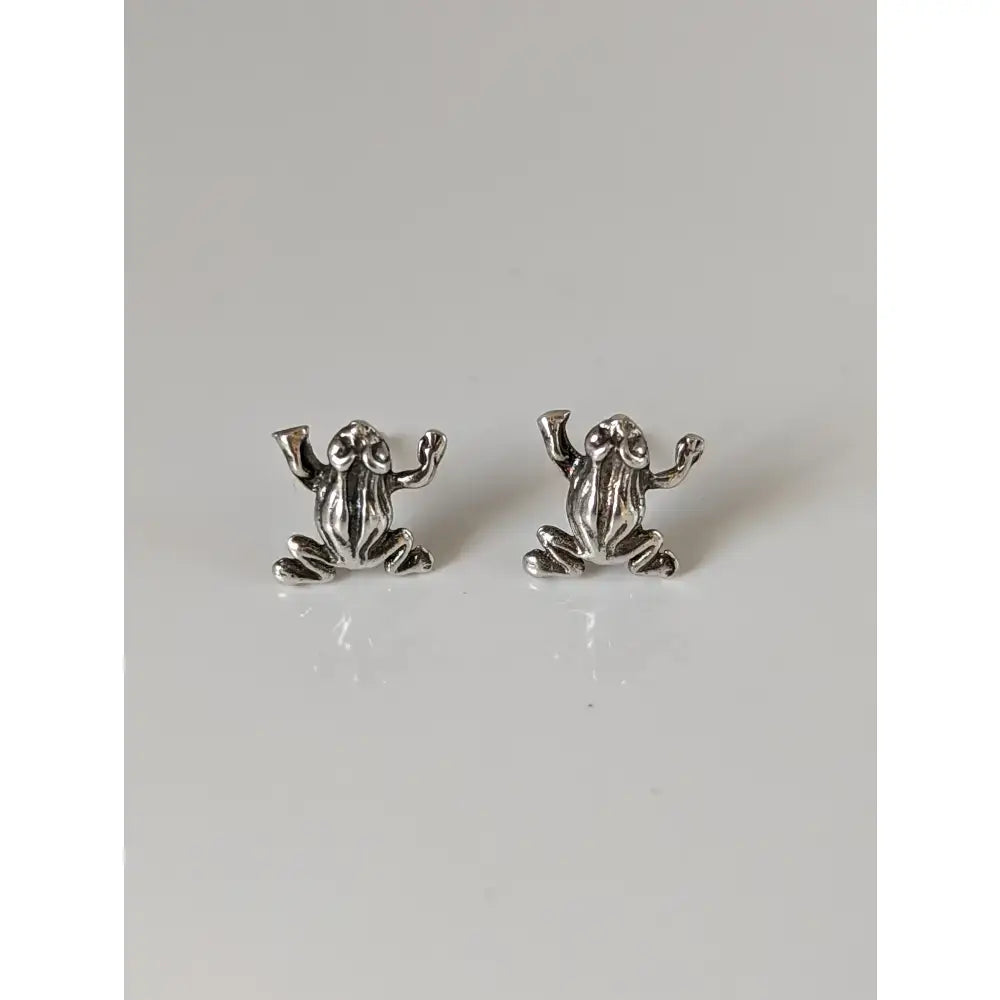 Silver steed leap frog stud earrings with detailed textured surfaces in a shiny silver finish for everyday wear