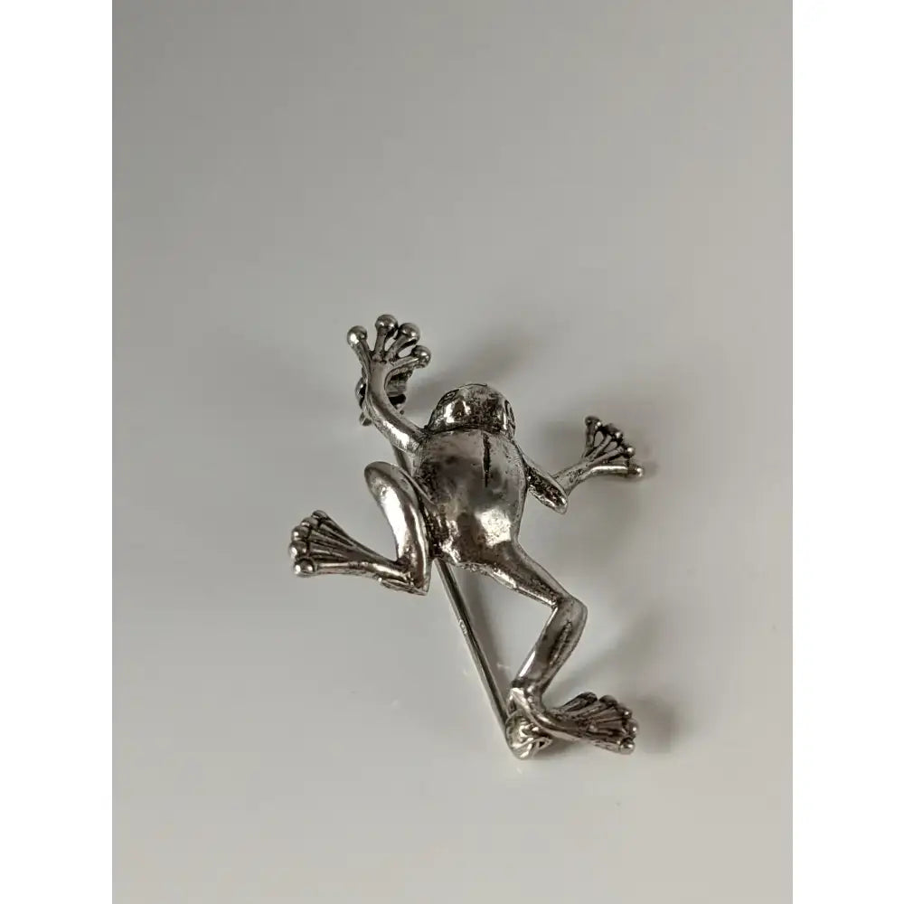 Silver steed leaping frog silver brooch with detailed limbs and textured skin perfect for equestrian jewelry fans