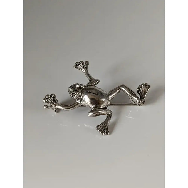 Silver steed leaping frog silver brooch with detailed limbs and textured skin perfect for equestrian jewelry fans