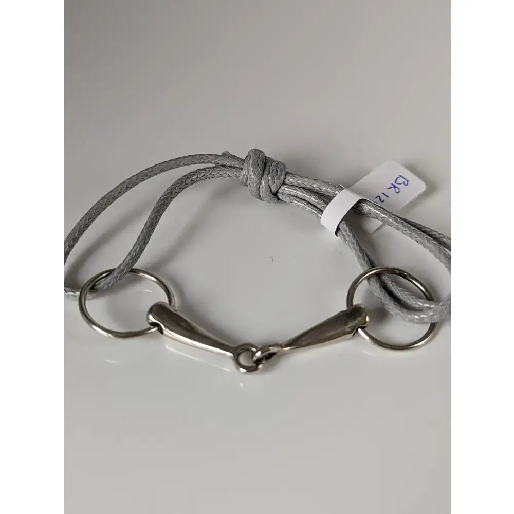 Gray braided snaffle cord bracelet with silver steed leather and silver-toned horsebit buckle detail