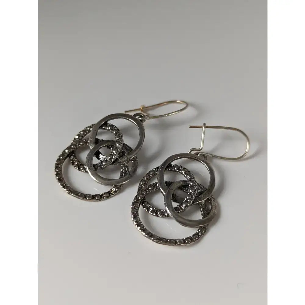 Silver steed linked rings dropped earrings with silver hoops, interlocking circles, and dark stone details