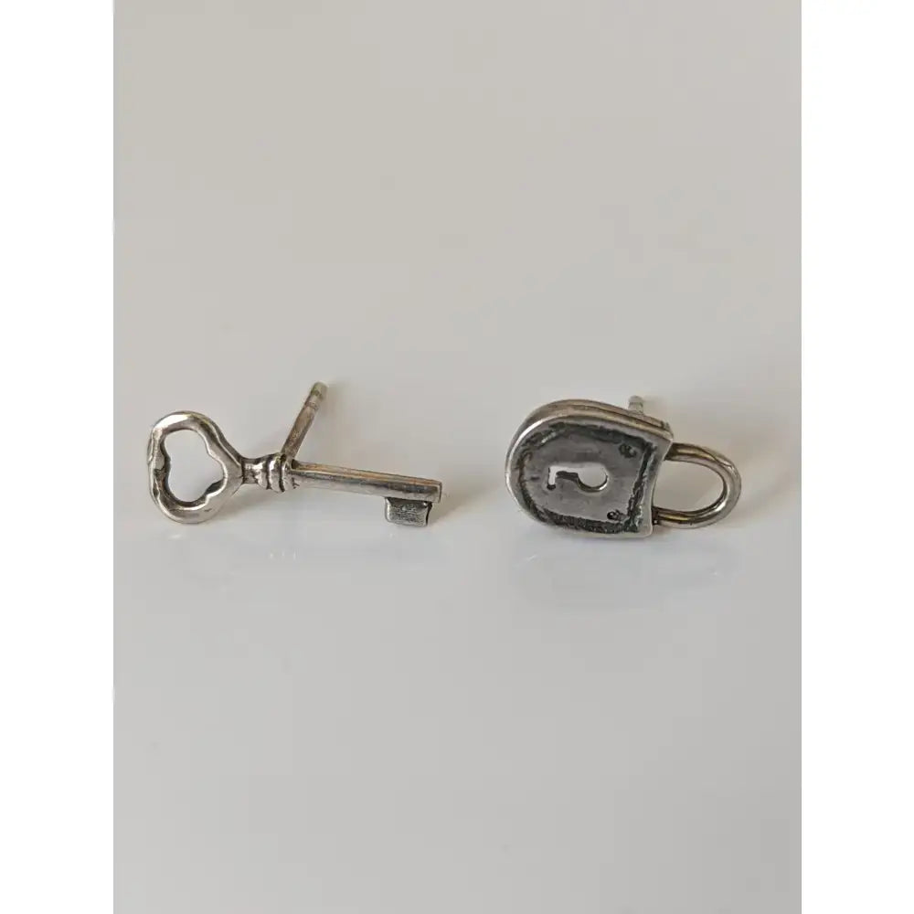 Silver steed lock and key stud earrings featuring silver key stud earrings with intricate detailing