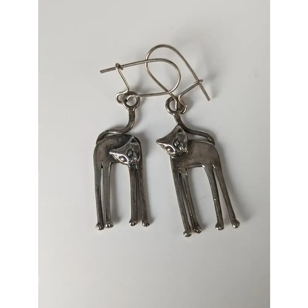Silver steed long silver cat earrings with slender stylized design and simple wire hooks for cat lovers