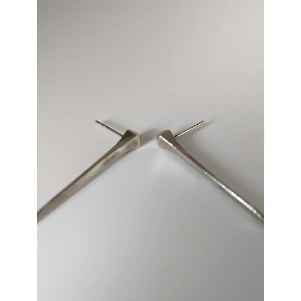 Silver steed long hoof nail stud earrings with angular silver tone and sleek polished metallic finish