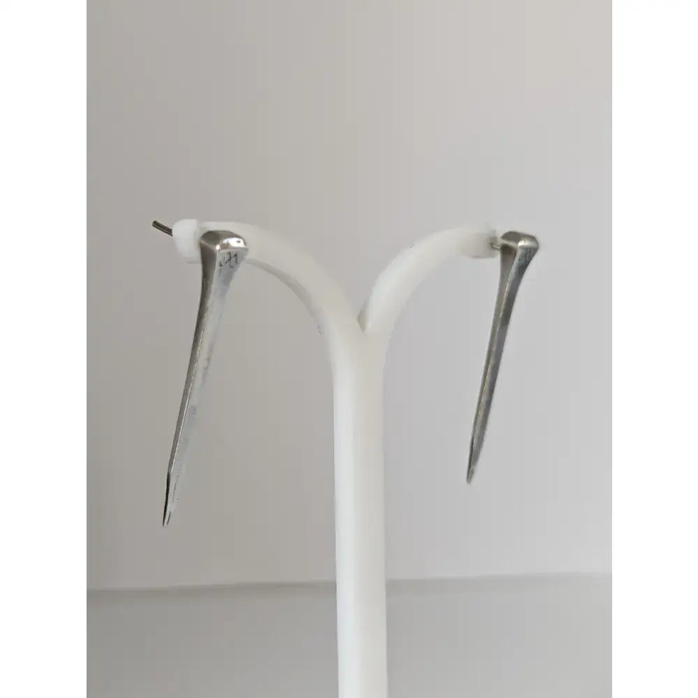 Silver steed long hoof nail stud earrings in silver tone with polished finish and subtle engraved details