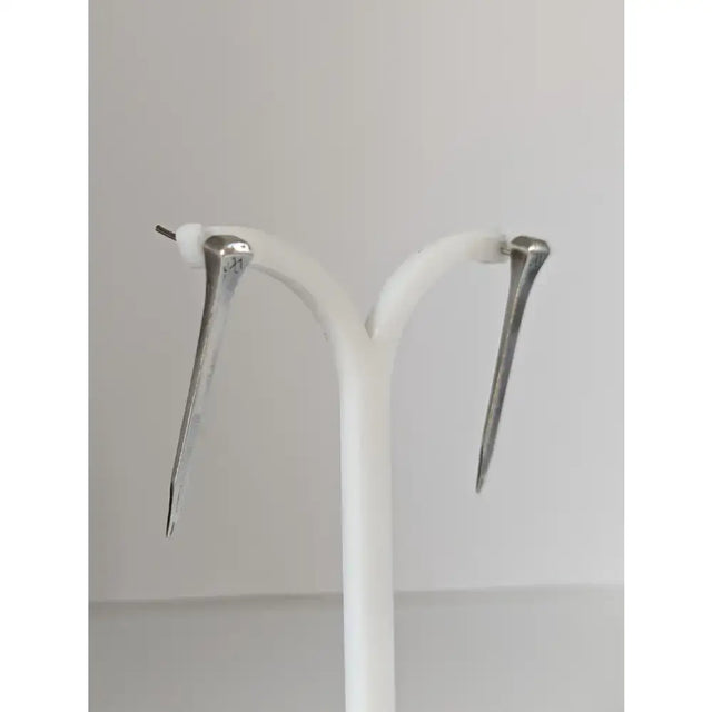 Silver steed long hoof nail stud earrings in silver tone with polished finish and subtle engraved details
