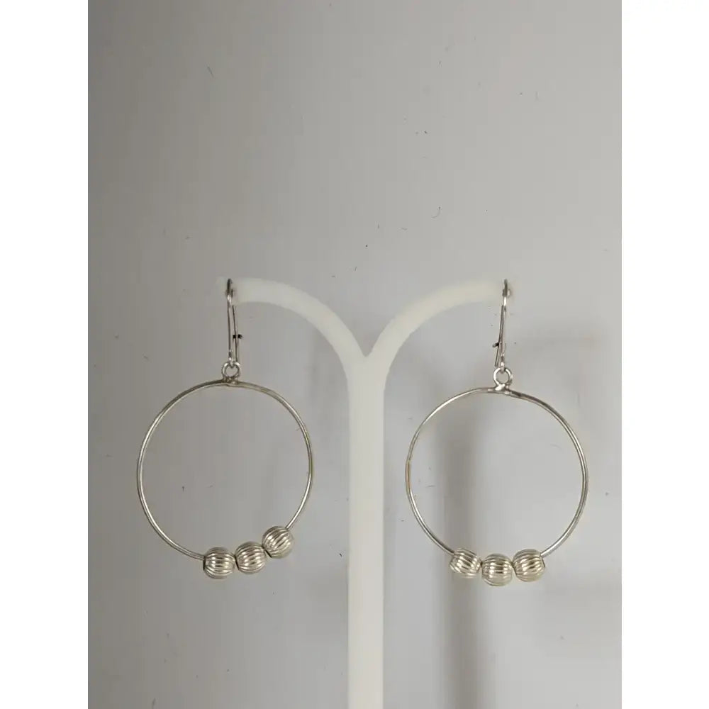 Silver steed loop sterling silver hoop earrings with three textured buds dangling from each circle