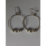 Silver steed loop buds dangling earrings featuring silver hoops with three textured sterling silver beads each