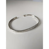 Silver steed magnetic solid silver bracelet featuring a sleek hammered cuff with rounded ends and minimalist design