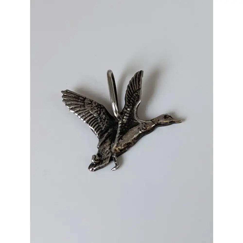 Silver steed malard high-polished silver pendant shaped like a detailed silver-colored metal duck with a top loop