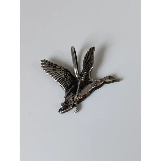 Silver steed malard high-polished silver pendant shaped like a detailed silver-colored metal duck with a top loop
