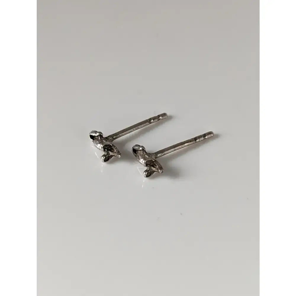 A pair of silver steed mouse stud earrings with tiny detailed miniature dachshund figures in silver sterling