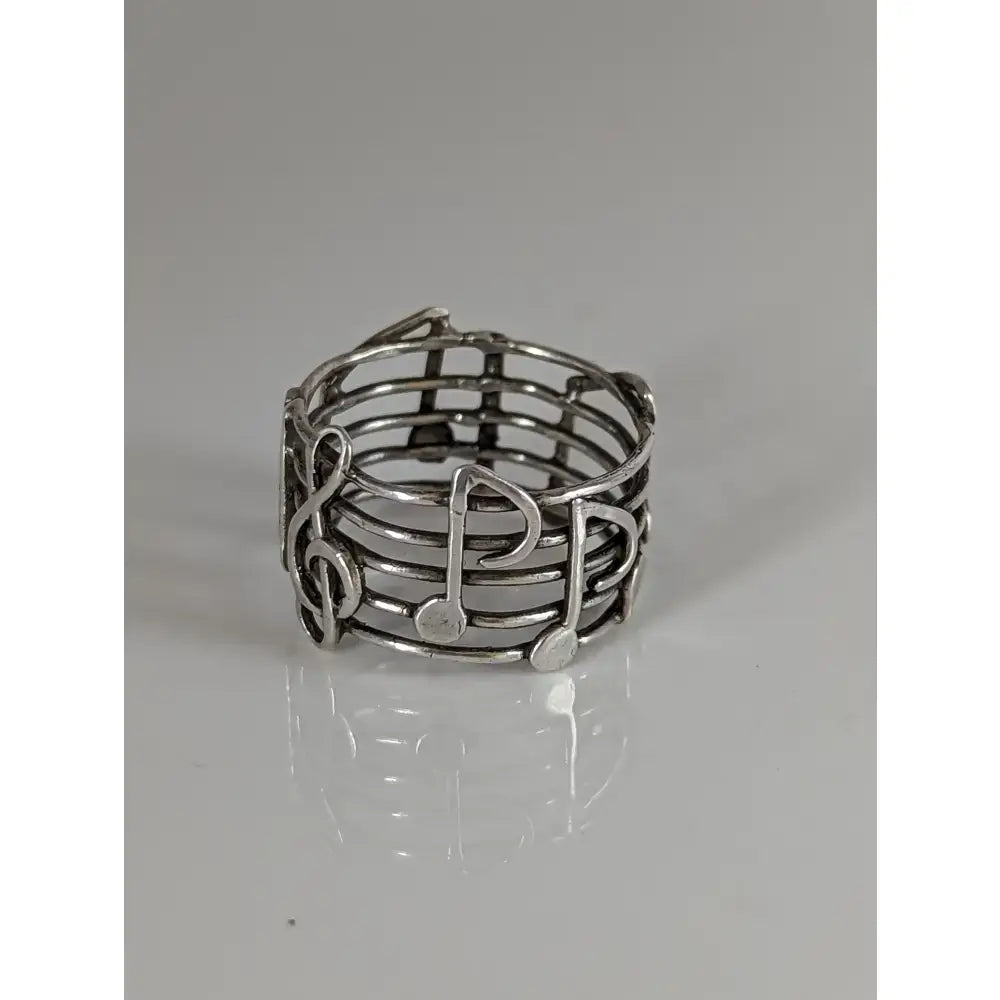 Silver steed music notes band silver ring with wire-woven design featuring treble clefs and eighth notes perfect equestrian jewelry
