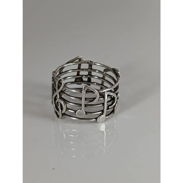 Silver steed music notes band silver ring with wire-woven design featuring treble clefs and eighth notes perfect equestrian jewelry