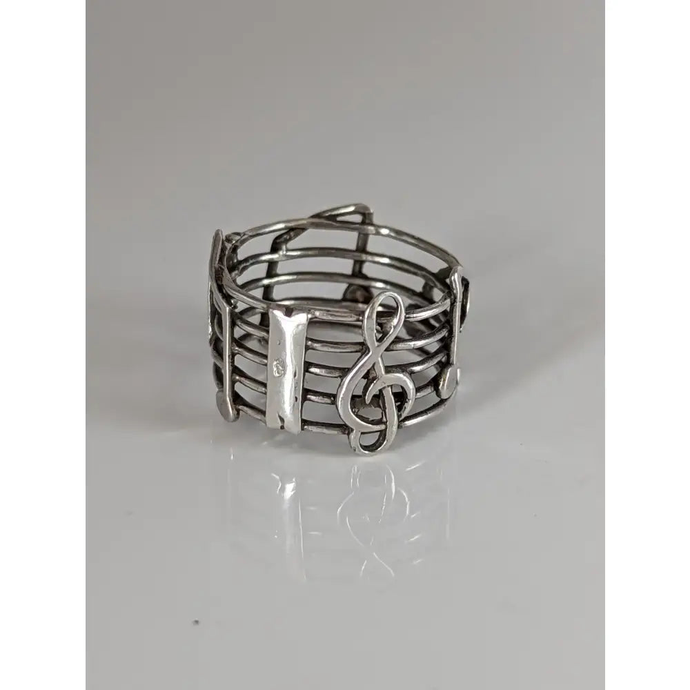 Silver steed music notes band is a silver ring featuring a treble clef and staff design perfect for equestrian jewelry fans