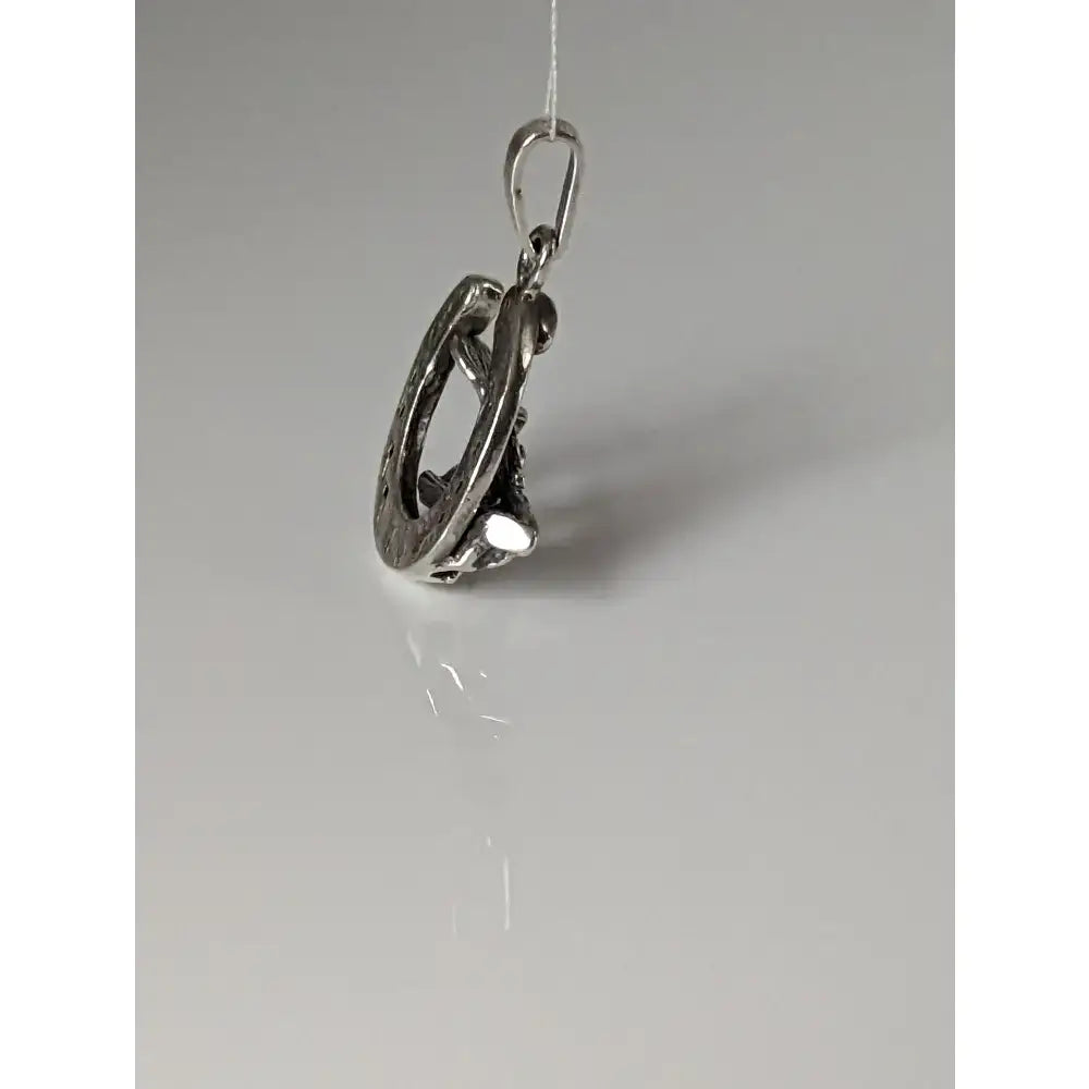 Silver steed oak horseshoe silver pendant featuring a silver-toned metal with interlocking rings and small stones
