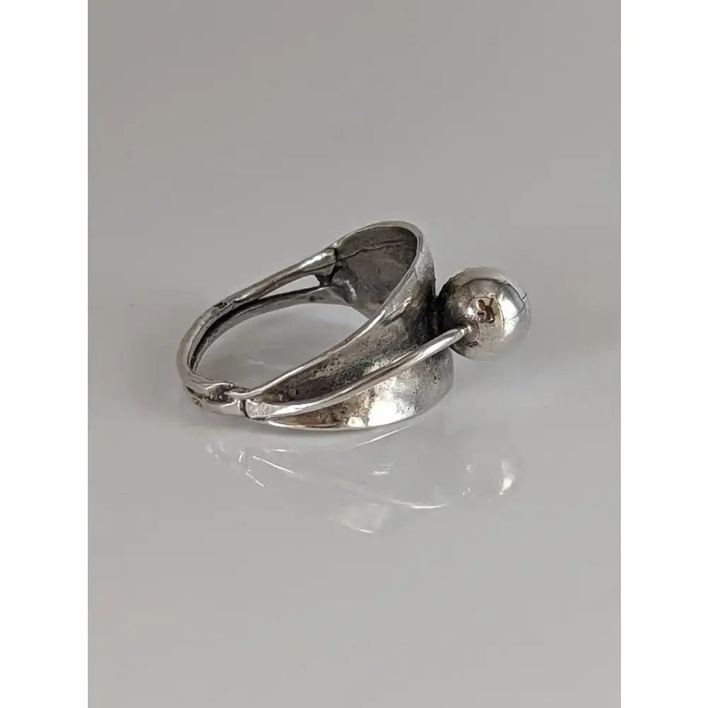 Silver steed round bud ring with a textured silver-toned sculptural band and a polished spherical accent