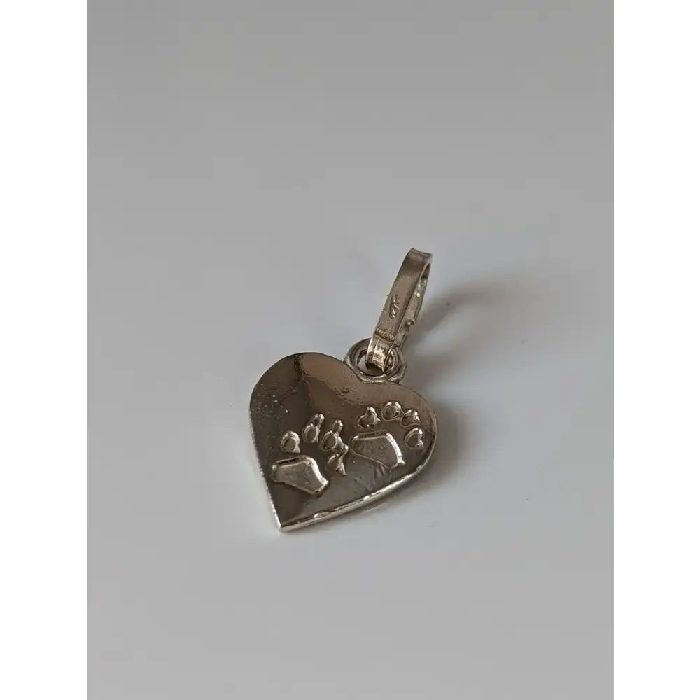 Silver steed heart silver pendant with engraved paw prints and polished metallic finish in silver pendant style