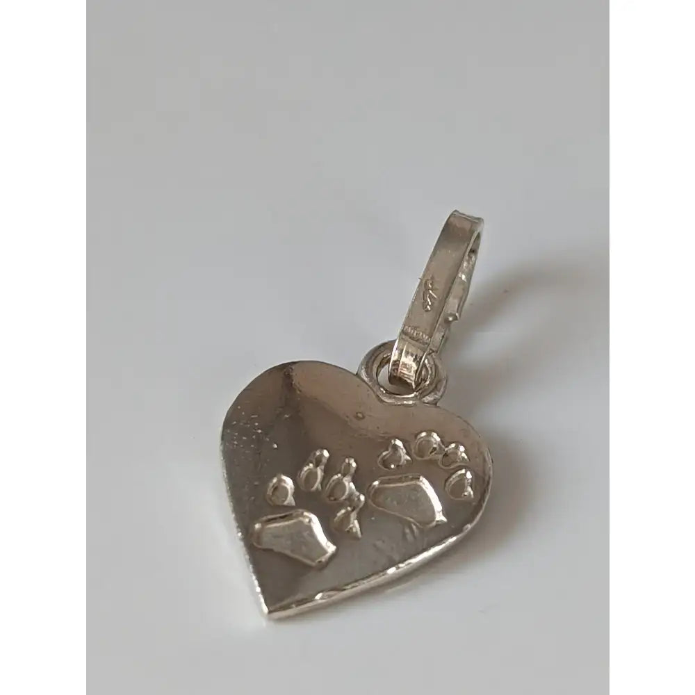 Silver steed heart silver pendant with engraved paw prints and polished silver finish