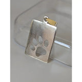 Silver steed paw print tag silver pendant with a silver rectangular pendant and cut-out paw print design and gold bail