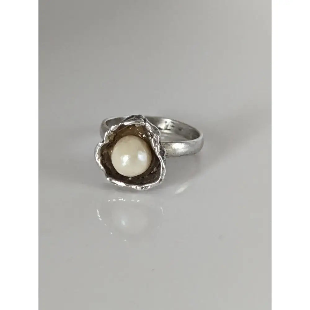 Silver steed pearl flower silver ring with a textured organic shell setting holding a creamy white pearl perfect for equestrian jewelry
