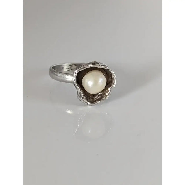 Silver steed pearl flower silver ring with a textured shell-like setting holding a lustrous white pearl for equestrian jewelry