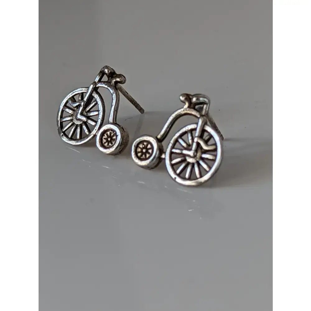 Silver steed penny farthing bike stud earrings with intricate spokes and classic vintage high-wheel design
