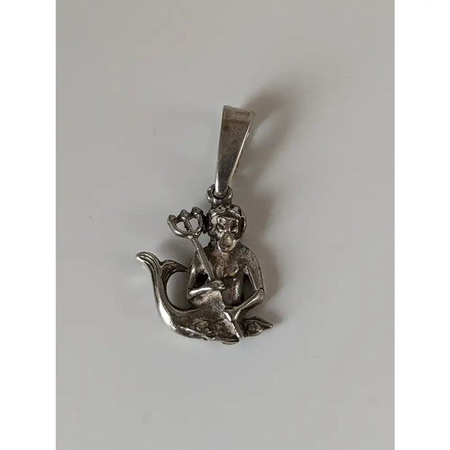 Silver steed poseidon sterling silver pendant featuring a monkey with trident seated on a fish-shaped base