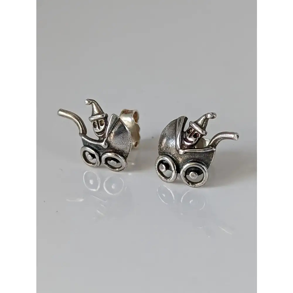 Silver steed pram sterling silver stud earrings with whimsical jester design and detailed wheels in polished finish