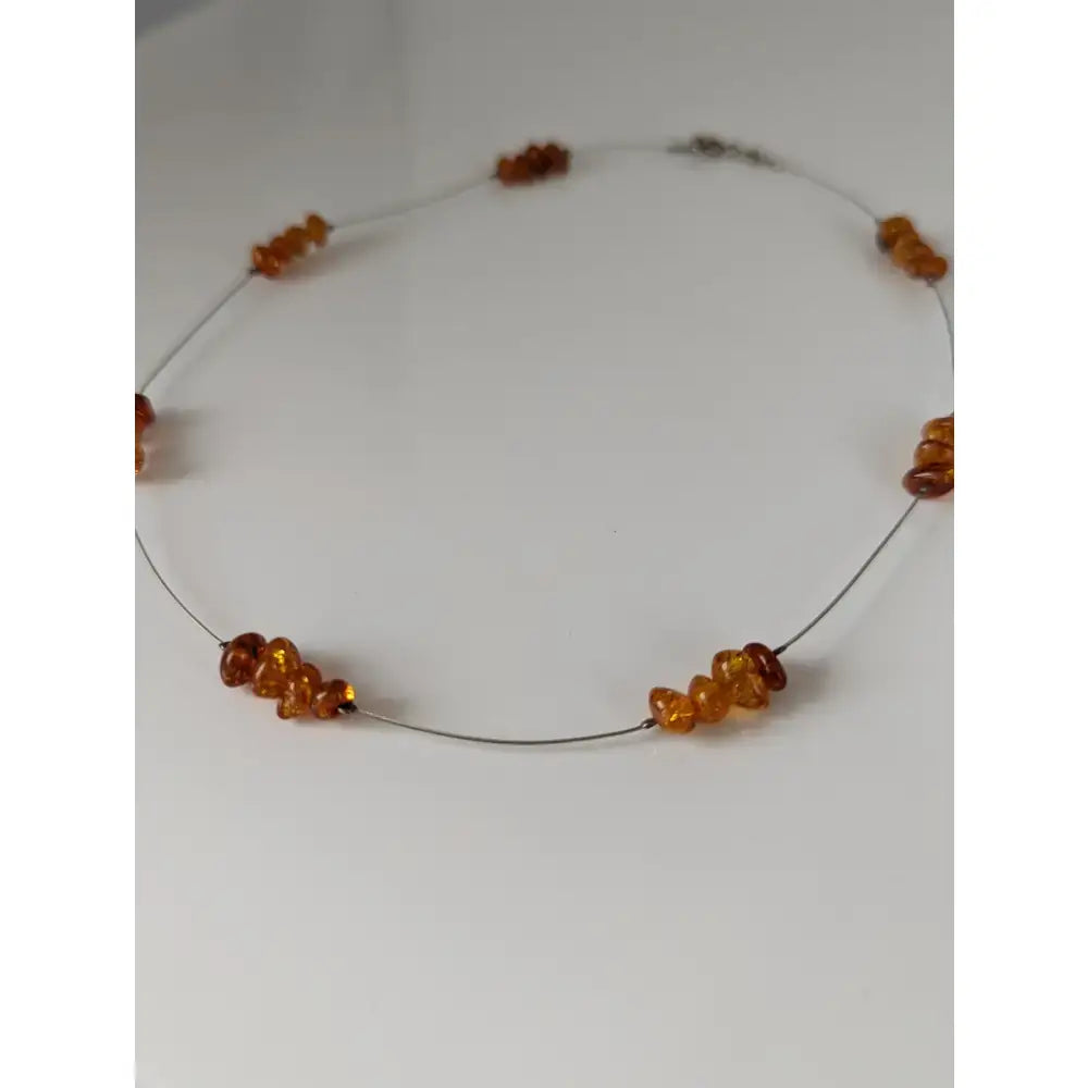Silver steed real delicate necklace with genuine amber real amber bead in warm amber tones on thin wire