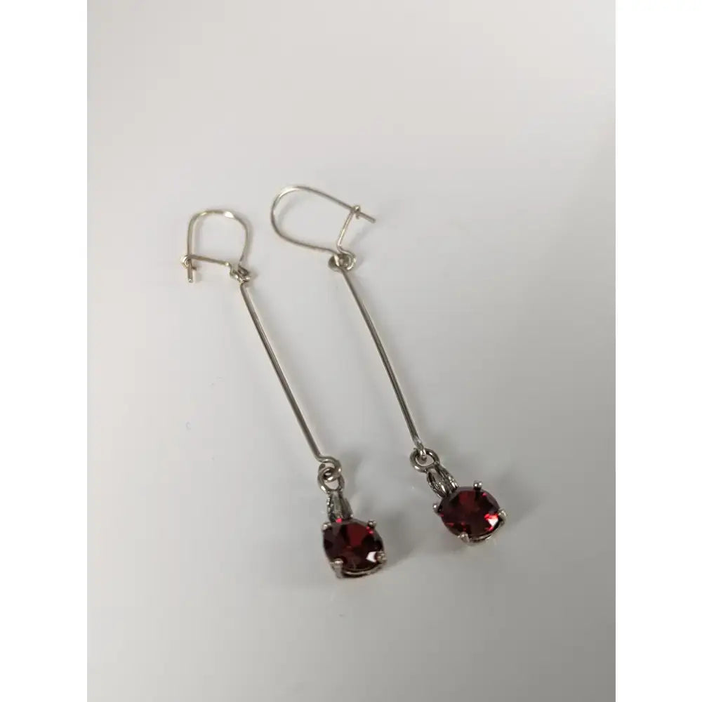 Silver steed red crystal dropped earrings with faceted deep red gemstones in a sleek silver drop design