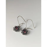 Silver steed red crystal sunflower dropped earrings with deep red gemstone and intricate silver spiky metalwork