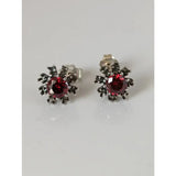 Silver steed red crystal sunflower stud earrings with round garnet stone and blackened metal detailing