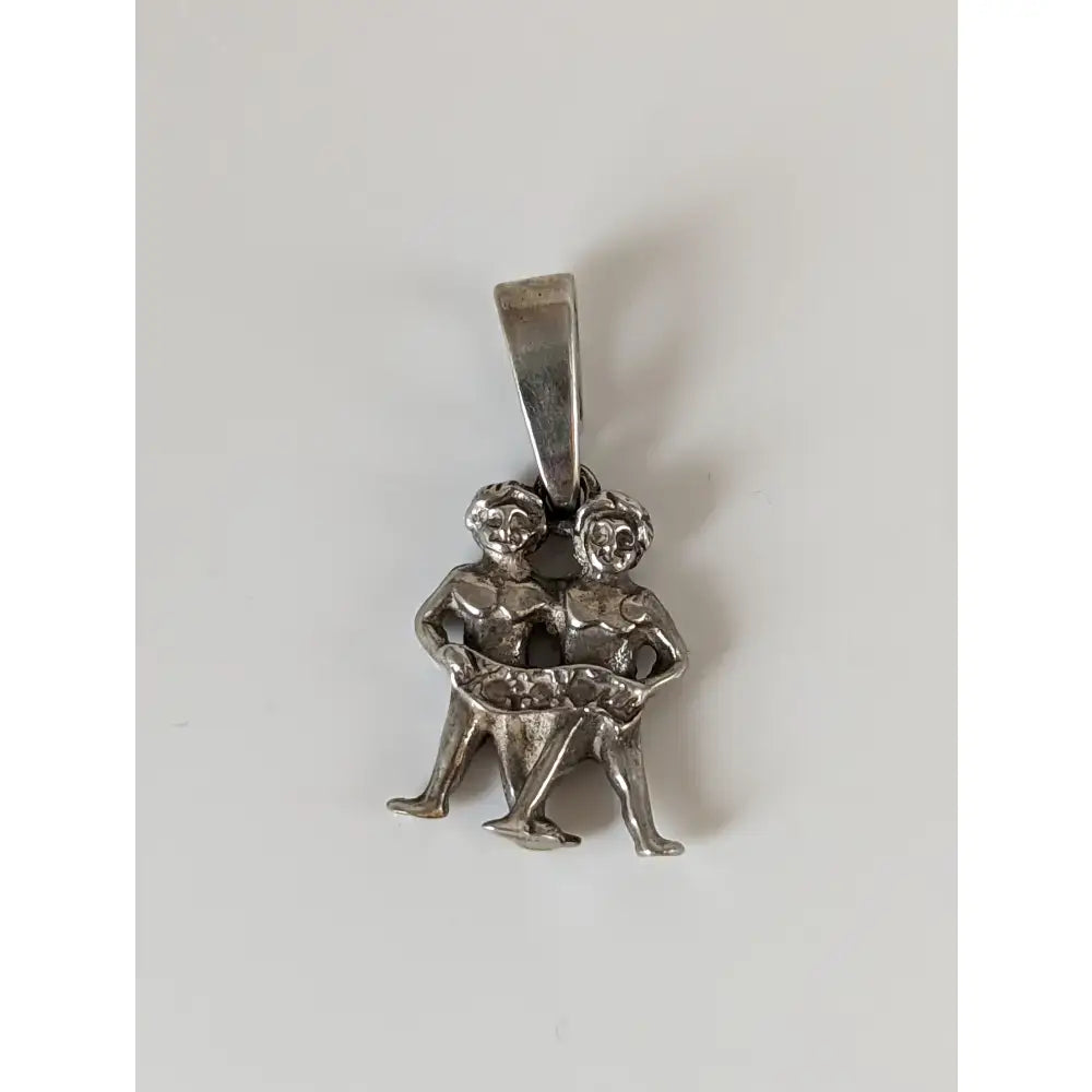 Silver steed romans twins silver pendant featuring silver pendant with two intertwined zodiac figures