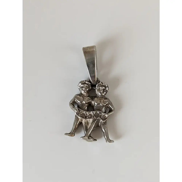 Silver steed romans twins silver pendant featuring silver pendant with two intertwined zodiac figures
