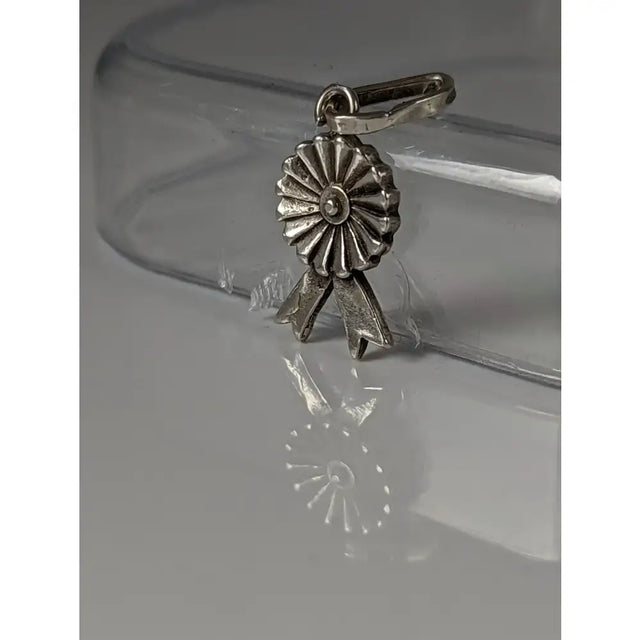 Silver steed rosette sterling silver pendant with detailed petal and bow design as a metallic ribbon award charm