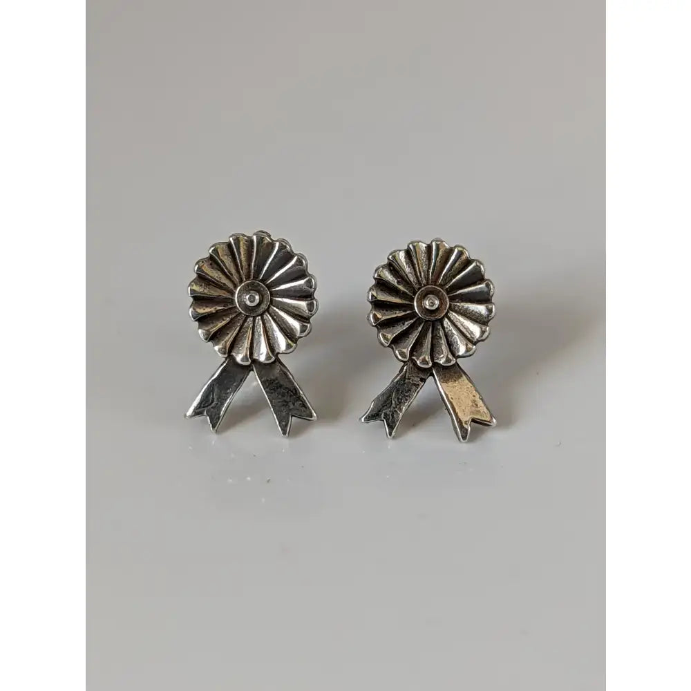 Silver steed rosette stud earrings with silver ribbon sunburst design and textured metallic finish