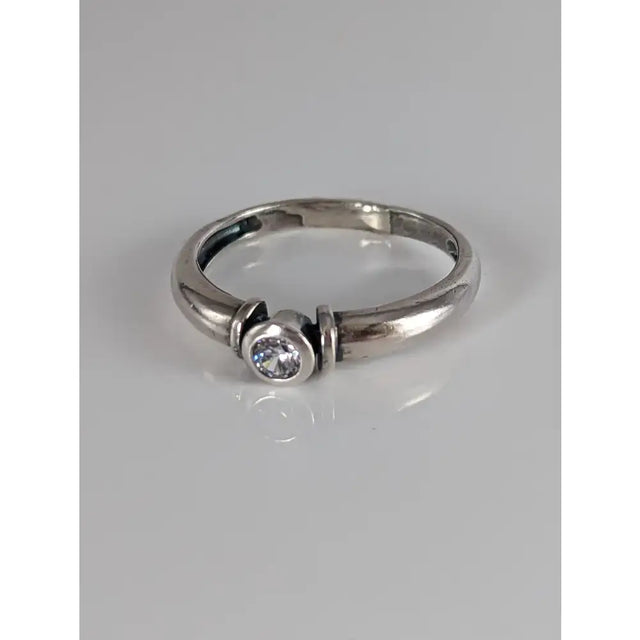 A sleek silver steed silver round zirconia ring with a single clear round-cut gemstone in a modern design