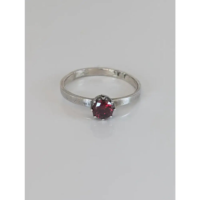 Silver steed silver ruby zirconia ring with a delicate silver band and a single deep red round-cut stone