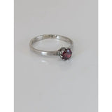 Silver steed silver ruby zirconia ring with a textured band and a round deep red gemstone in a six-prong setting