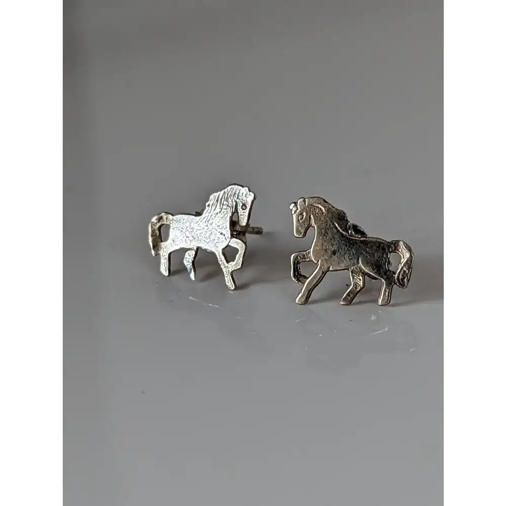 Silver steed running horse stud earrings with textured metallic finish and detailed silver horse stud design
