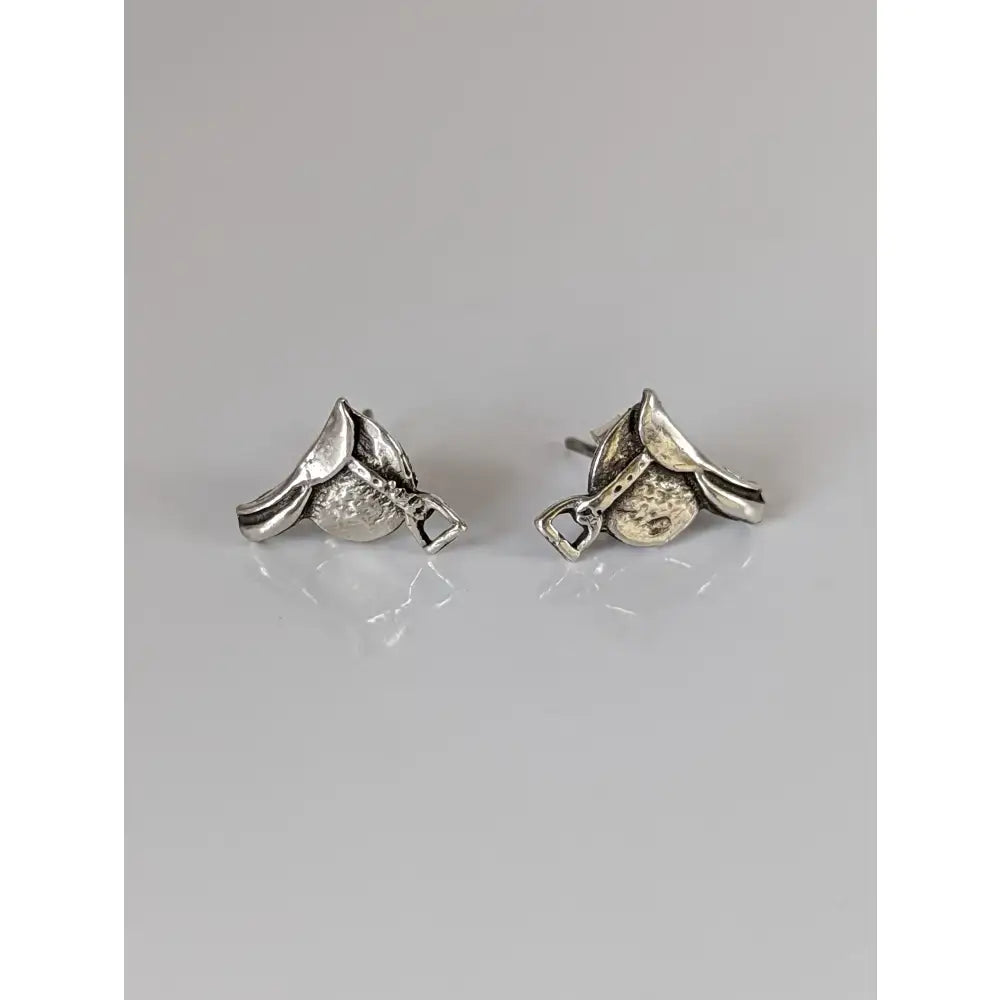 Silver steed earrings shaped like horse riding boots with textured leather details and a small silver buckle accent