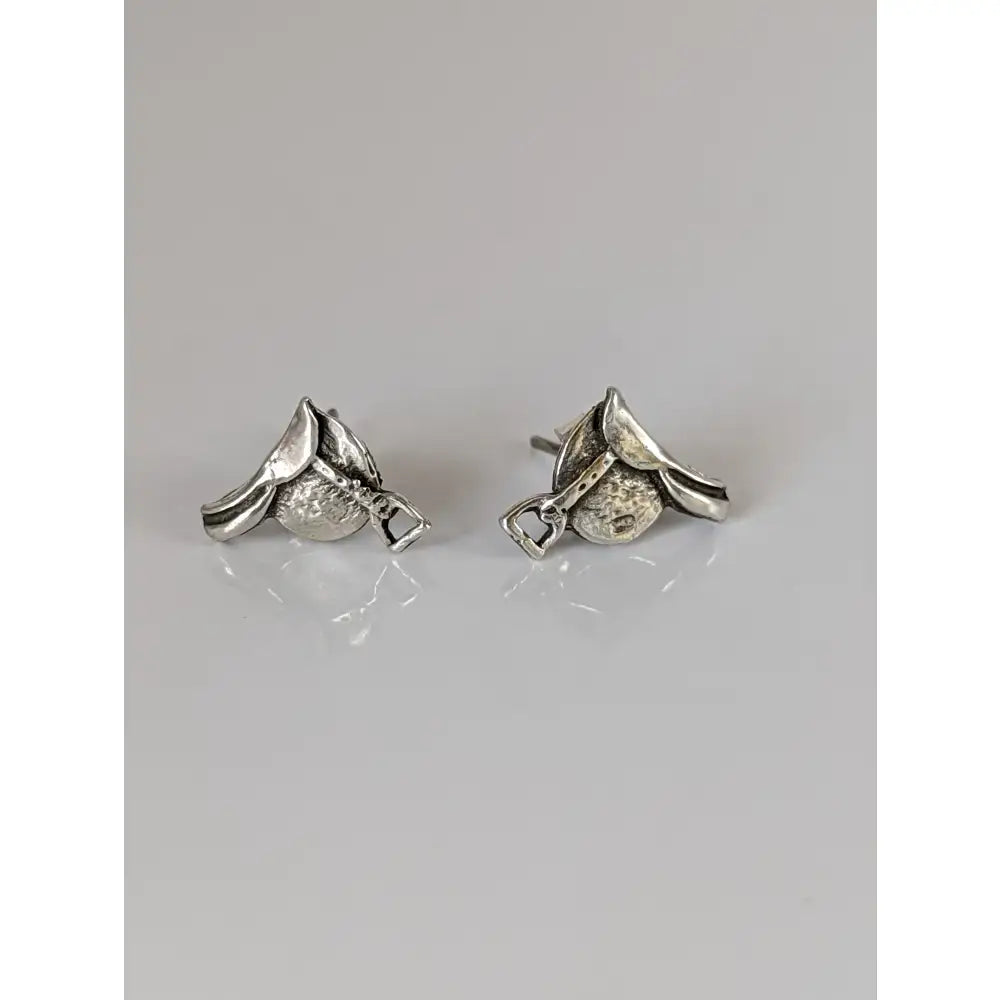 Silver steed silver saddle stud earrings with textured metallic finish and detailed craftsmanship in silver