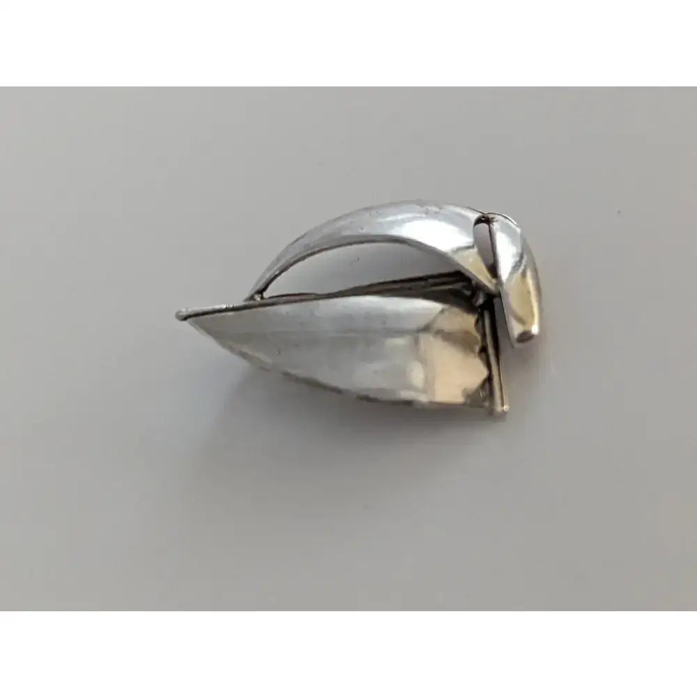 Silver steed sailing boat silver pendant shaped like a polished silver leaf with intricate metalwork details