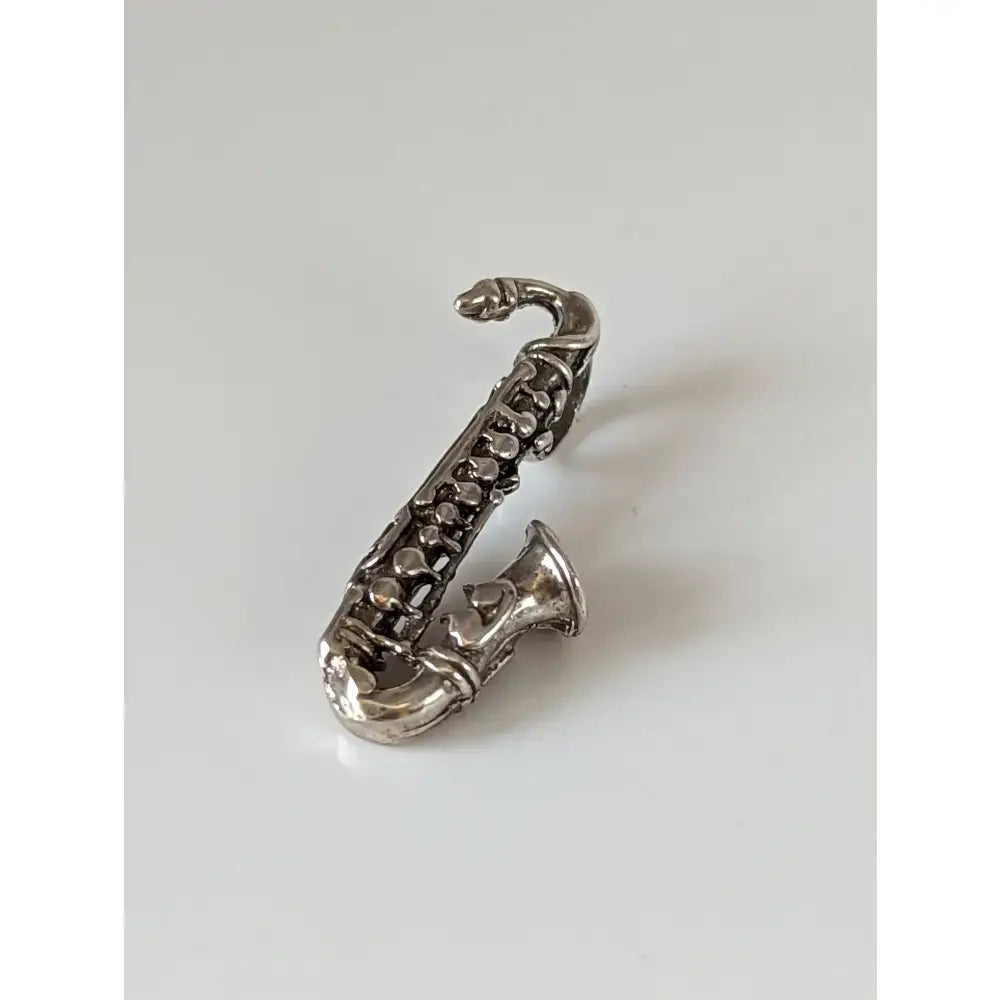 Silver steed saxophone silver pendant featuring a polished silver pendant with intricate saxophone key details
