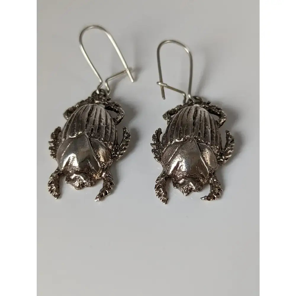 Silver steed scarab handcrafted silver earrings with detailed textured wings and legs in scarab dropped earrings style