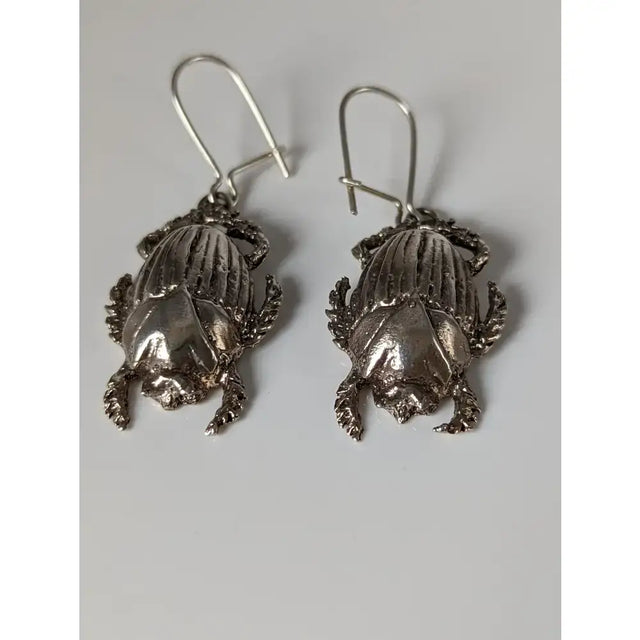 Silver steed scarab handcrafted silver earrings with detailed textured wings and legs in scarab dropped earrings style