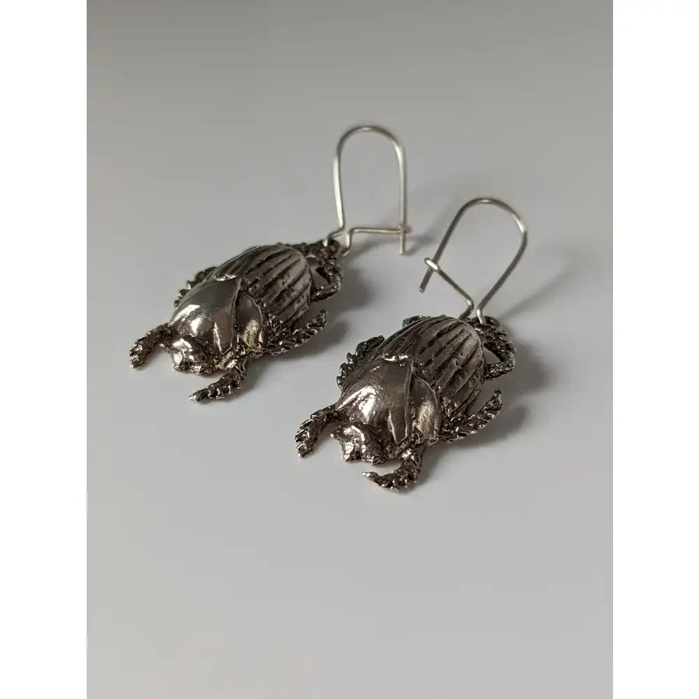 Silver steed scarab handcrafted silver scarab dropped earrings with detailed textured surfaces and hook clasps