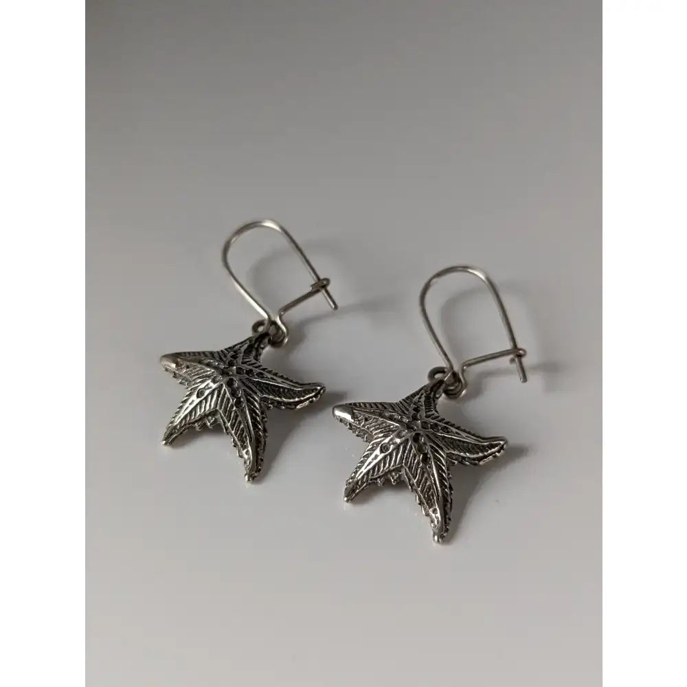 Silver steed sea star dropped earrings featuring silver starfish design with intricate leaf detailing and hook closures